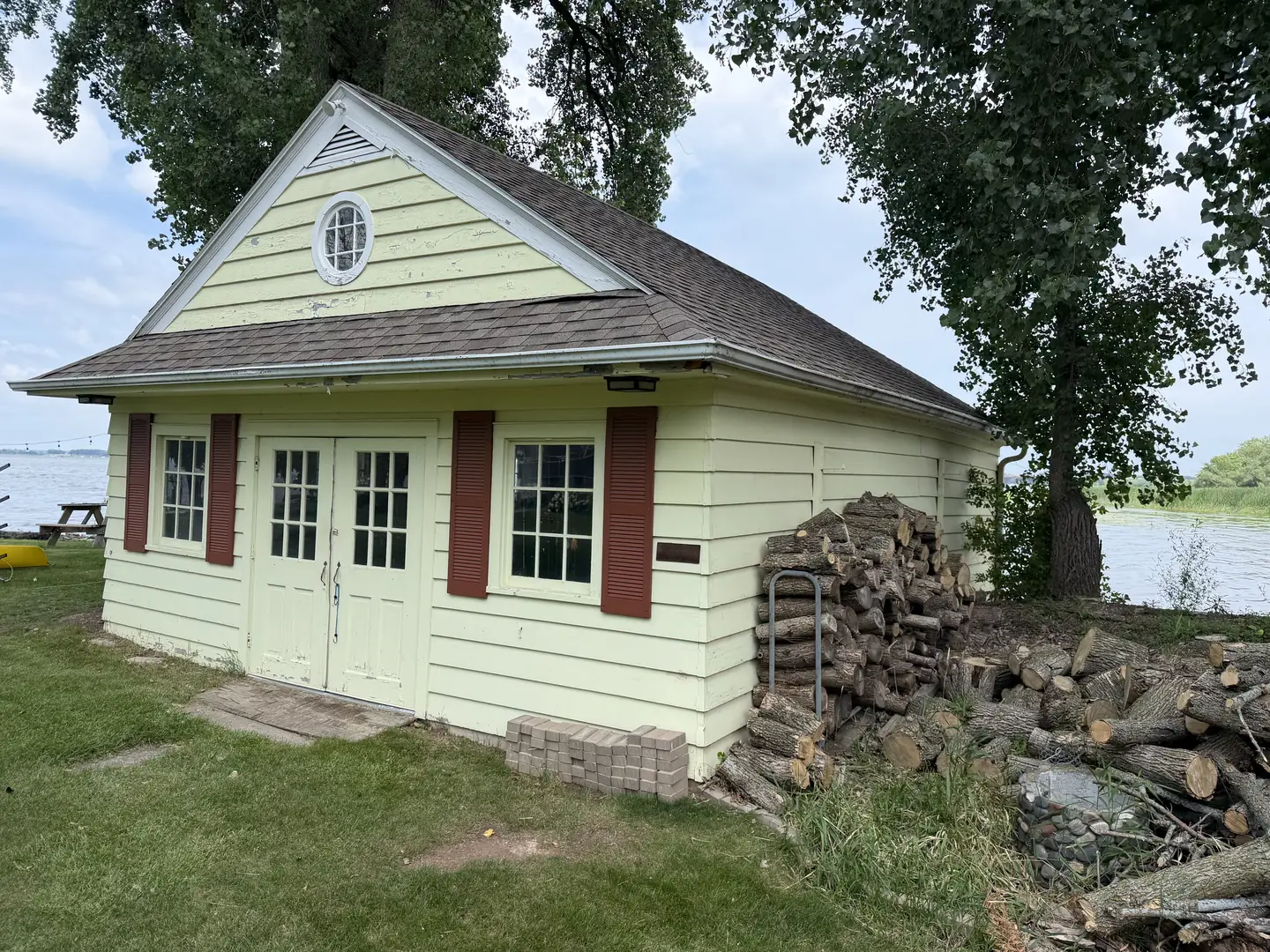 The same boathouse from the water side, before