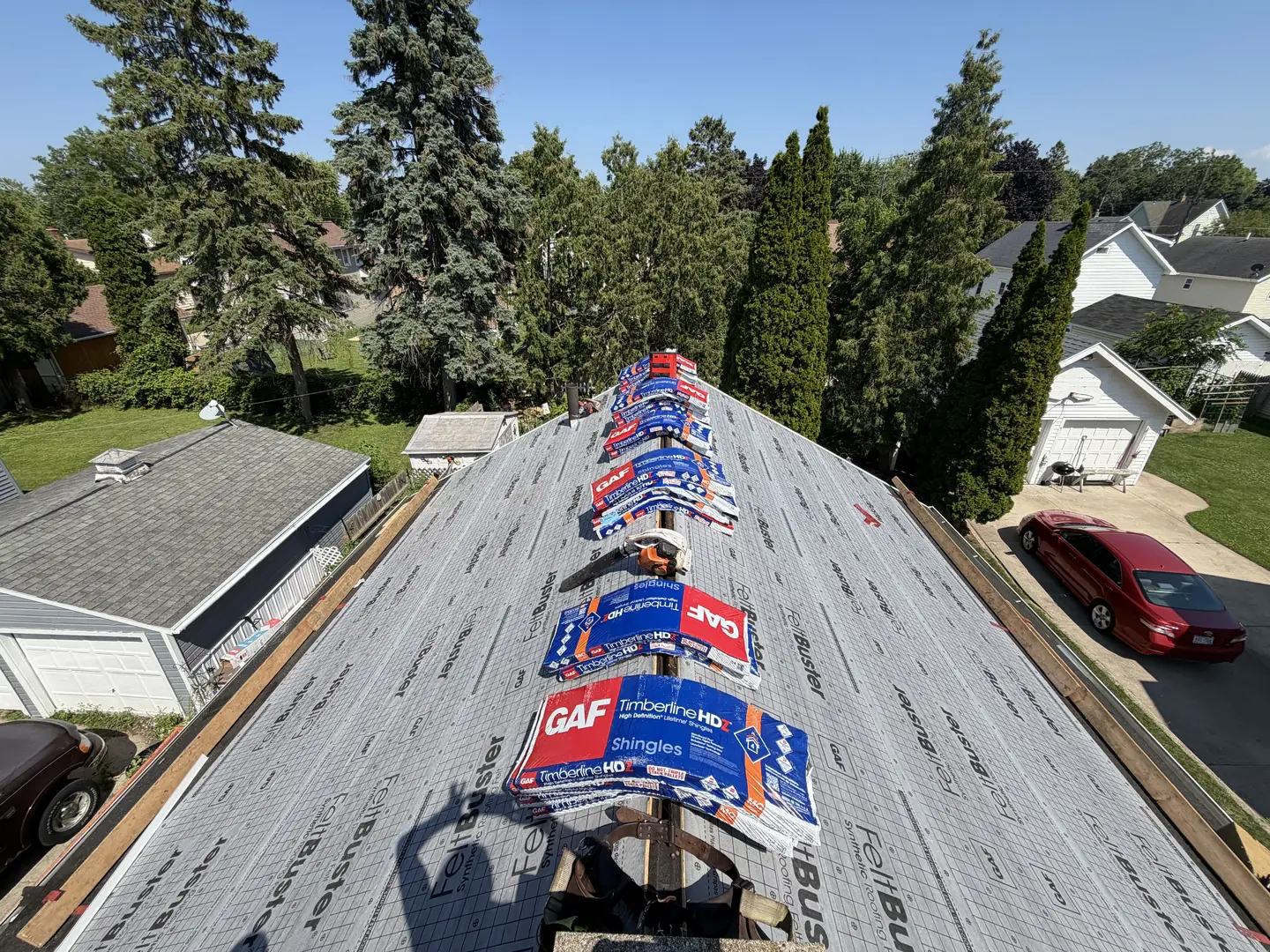 GAF Timberline HD bundles loaded on the ridge and spread out so nothing sits on one rafter.