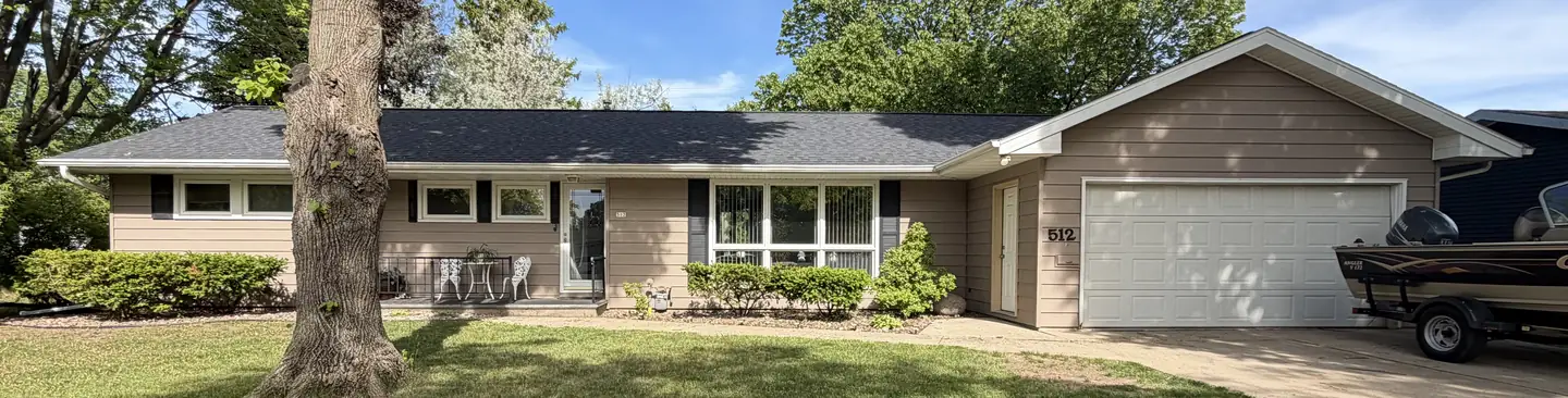 A ranch home and attached garage with new architectural shingles